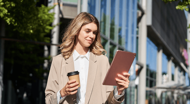 Woman with tablet and coffee setting up