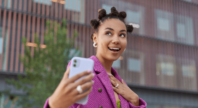 Woman with smartphone taking selfie