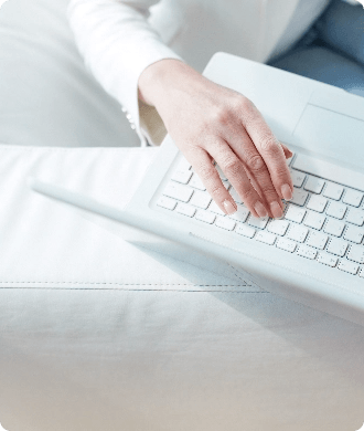 Hands typing on laptop keyboard